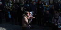 LVIV, UKRAINE - MARCH 25: Tatiana Rurak kneels as she holds her daughter, Oleksandra Rurak, as they watch Ukrainian military members carry the casket of her husband Volodymy Rurak into the Church of the Most Holy Apostles Peter and Paul for his funeral on March 25, 2022 in Lviv, Ukraine. Mr. Rurak was killed in the eastern part of Ukraine fighting against the Russian military. One month since Russia's Feb. 24 attack on Ukraine, estimated military casualties for both sides vary widely. As of March 12, Ukraine said that 1,300 of its soldiers had been killed, while the U.S. estimated between 2,000 and 4,000. The consensus of foreign governments is that Russian troop losses have been far greater, with NATO estimating yesterday that 7,000–15,000 soldiers had been killed in action, with thousands more wounded. (Photo by Joe Raedle/Getty Images)
