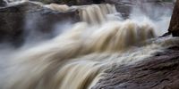 A slow shutter speed on the camera transforms Friday morning’s wild flow through the Falls into dream-like ribbons of water. (Photo: John Yeld)