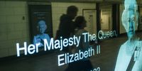 Commuters pass by a poster of the late Queen Elizabeth II in the London underground on 10 September 2022. (Photo:  EPA-EFE / Yoan Valat)
