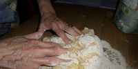 The potato mix is flipped onto the floury part of the table and Angelina folds it. Photo: Margot Patterson