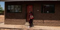 Marcela Viemba, who moved to Mahikeng in 2008, stands outside her former home in Pomfret. Photo: Shaun Swingler