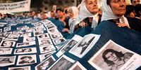 Members of the Argentine human rights group Madres de Plaza de Mayo gather 24 March, 2000, in Buenos Aires on the 24th anniversary of the coup which brought the military to power in 1976. The group brought a giant blanket emblazoned with the photos of thousands who disappeared during the dictatorship. (Photo: Marcon Adandia)