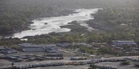 The Blue Nile flows downstream towards Sudan as cement trucks sit parked in the foreground at the site of the under-construction Grand Ethiopian Renaissance Dam in the Benishangul-Gumuz Region of Ethiopia. (Photo: Bloomberg via Getty Images / Zacharias Abubeker)