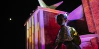 A young girl looks out from the Brixton Church in Putney Road that was lit in neon colours and topped with giant traffic cones, on 6 February 2022. (Photo: James Puttick)