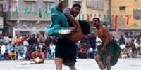 epa09619437 Zamir Sheedi (L) and Sajjad (R) wrestle during a traditional Sindhi Malakhra wrestling event in Karachi, Pakistan, 03 December 2021. A Malakhra match begins with both wrestlers tying a twisted cloth around the opponent's waist. Each one then holds onto the opponent's waistcloth and tries to throw him to the ground.  EPA-EFE/SHAHZAIB AKBER
