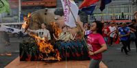 Protesters burn effigies of President Ferdinand Marcos Jr. (L) and Vice-President Sara Duterte (R) along a road leading to the Philippine Congress in Quezon City, Metro Manila, Philippines, 22 July 2024. The scheduled State of the Nation Address (SONA) of President Ferdinand Marcos Jr., at the Philippine Congress on 22 July was met with street protests calling for reforms in the country’s economic, labor, social services, human rights and political sectors.  EPA-EFE/ROLEX DELA PENA