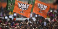 Bharatiya Janata Party supporters hold BJP flags as Indian Prime Minister Narendra Modi addresses an election rally in Nagrijuli, Baksa district of Assam, India, 03 April 2021. (Photo: EPA-EFE / Pranabjyoti Deka)