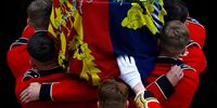 WINDSOR, ENGLAND - SEPTEMBER 19: Pall bearers carry the coffin of Queen Elizabeth II with the Imperial State Crown resting on top into St. George's Chapel on September 19, 2022 in Windsor, England. The committal service at St George's Chapel, Windsor Castle, took place following the state funeral at Westminster Abbey. A private burial in The King George VI Memorial Chapel followed. Queen Elizabeth II died at Balmoral Castle in Scotland on September 8, 2022, and is succeeded by her eldest son, King Charles III. (Photo by Jeff J Mitchell/Getty Images)
