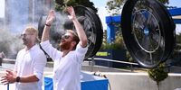 Tennis supporters cool down with mister fans as play is suspended on the outside courts due to the extreme heat on day 10 of the 2026 Australian Open. (Photo: EPA / Joel Carrett)