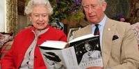 Queen Elizabeth II sits with the Prince Charles, Prince of Wales and studies one of the first copies of 'Queen Elizabeth The Queen Mother, The Official Biography' in a living room at Birkhall the Scottish home of  the Prince and Duchess of Cornwall on 2 September 2009 Balmoral Estate, Scotland. The book which was written by the renowned author William Shawcross, took six years to complete, and tells the story of the Queen Mother through the 20th century. (Photo: John Stillwell-WPA Pool/Getty Images)