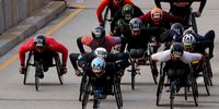 Daniel Romanchuk (bottom) of the United States leads the men's wheelchair field during the 2023 Chicago Marathon at Grant Park on October 08, 2023 in Chicago, Illinois. (Photo by Michael Reaves/Getty Images)