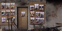 Placards showing photos of Israeli hostages held by Hamas hang in a destroyed house in Be’eri, Israel on 20 December 2023 before a press conference to mark 75 days since the attack. (Photo by Maja Hitij / Getty Images)