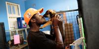 Durban Deep, South Africa - March 3, 2019: 23-year-old, Fuzile Jwara, arrives by kissing puppies that are receiving medical attention at CLAW (Community Led Animal Welfare). Jwara volunteers most of his spare time to working at the animal welfare organisation despite living with FAPS (Familial adenomatous polyposis), a genetic disorder that could become cancer. Fuzile is enrolled at the University of Johannesburg doing a BA degree. Picture: DANIEL BORN for DAILY MAVERICK