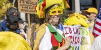 A 'No Kings' protester dressed in a taco costume in Grand Park in Los Angeles on 18 October.  (Photo: Jill Connelly / EPA)