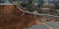 epa09887988 A completely destroyed road with flood debris near Durban, South Africa, 13 April 2022. At least 250 people have died as a result of heavy flooding in the Eastern Coastal area. Key roads in the area have been damaged and mudslides destroyed houses. The South African National Defense Force have been called in to assist as President Cyril Ramaphosa visited the area on 13 April.  EPA-EFE/STR