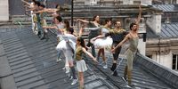 PARIS, FRANCE - JULY 26: Dancers perform on a roof during the opening ceremony of the Olympic Games Paris 2024 on July 26, 2024 in Paris, France. (Photo by Dan Mullan/Getty Images)