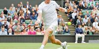 Kevin Anderson stretches to play a forehand in his singles second-round match against Novak Djokovic of Serbia at Wimbledon in 2021. (Photo: Mike Hewitt / Getty Images)