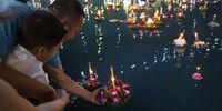 People float Krathong offerings into a lake during the annual Loy Krathong festival in Bangkok, Thailand, 15 November 2024. Loy Krathong is celebrated on the full moon day of the twelfth lunar month according to the Thai lunar calendar, which falls on 15 November this year. The annual ancient ceremony, whose tradition dates back more than 700 years, involves floating lanterns and lotus-shaped trays containing flowers, candles and incense on rivers, lakes and canals to honor and seek forgiveness from the Goddess of Water with a prayer to let all the bad luck of the past year float away so that their misfortunes will be replaced with good fortune in the coming year.  EPA-EFE/NARONG SANGNAK