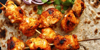 Tandoori chicken on the skewer.