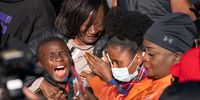 BRUNSWICK, GA - NOVEMBER 24: Jamie Cooper Jr., left, with his mother Dana Roberts and sister, Johneya Beckham, react as they listen to guilty verdicts for the defendants in the trial of the killers of Ahmaud Arbery on November 24, 2021 in Brunswick, Georgia. Greg McMichael, his son Travis McMichael, and a neighbor, William "Roddie" Bryan were found guilty in the February, 2020 fatal shooting of 25-year-old Ahmaud Arbery. (Photo by Sean Rayford/Getty Images)