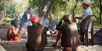 Professor Vanessa Hayes discussing the significance of the region with an extended Ju?'hoansi family who live today within the semi-desert Kalahari region of Namibia. The Nature study reveals this region was a human homeland 130000 years ago. Photo supplied.