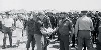 1985. South African Minister of Law and Order, Adriaan Vlok greeting members of the army.