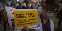 A doctor takes part in a protest against the Olympics in Tokyo on 23 June 2021. Protests have continued to take place in the run-up to the Games amid coronavirus fears. (Photo by Carl Court/Getty Images)