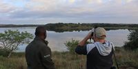 Rodolfo Cumbane with a fellow twitcher at the edge of a lake within Maputo National Park. (Photo: Keith Bain)