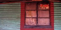 The window is covered with a cardboard box and tape at Zacarias Chirindza's home in the Phola township, Ogies. (Photo: Tshepiso Mabula ka Ndongeni)