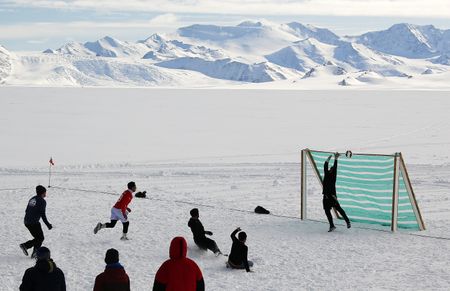 Antarctic researchers mark winter solstice with icy plunge