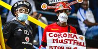 South African football fans cover themselves about Coronavirus fears during the Absa Premiership match between Bidvest Wits and Black Leopards at Bidvest Stadium on March 10, 2020 in Johannesburg, South Africa. (Photo by Lefty Shivambu/Gallo Images)