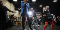 DAVENPORT, IOWA - FEBRUARY 01: Democratic presidential candidate Sen. Elizabeth Warren (D-MA) dances with a little girl on stage at the conclusion of a campaign rally with former Housing and Urban Development Secretary Julian Castro in the Mississippi Ballroom at the RiverCenter February 01, 2020 in Iowa City, Iowa. With the endorsement of the Des Moines Register newspaper, Warren is campaigning in Iowa ahead of the all-important February 03 caucuses while also juggling her mandatory attendance of the impeachment trial of U.S. President Donald Trump. (Photo by Chip Somodevilla/Getty Images)