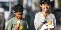 Children enjoy an ice-cream on Sea Point main road. Gelato is readily available with visitors and locals seen lining up for cones on hot days. (Photo: Leila Dougan)
