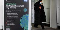A woman exits a National Health Service (NHS) centre in London, 20 March 2020. (Photo: EPA-EFE/ANDY RAIN)