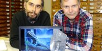 Dr Rob Gess (left) and Prof Per Ahlberg (right) with the cleithrum of Tutusius and an image of a Devonian tetrapod (picture by Steven Lang).