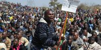 Mine workers chating songs abd carrying weapons while gathering outiside Nkaneng informal settlement near the Lonmin mine in Rustenburg north west demanding a wage increase from their employers. (Photo: Felix Dlangamandla (Foto24/Gauteng))