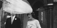 The veil of newly-wed bride Eileen Petticrew flies up in a gust of wind as she poses for photographs with husband Robert Greenhill outside St John the Evangelist Church, Notting Hill, London.   (Photo by Evening Standard/Getty Images)