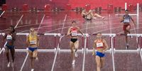 epa09388027 Sara Slott Petersen (back) of Denmark reacts after falling during heavy rain in the women's 400m hurdles semi final during the Athletics events of the Tokyo 2020 Olympic Games at the Olympic Stadium in Tokyo, Japan, 02 August 2021.  EPA-EFE/PETER KLAUNZER
