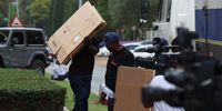 SIU members carry boxes into Maumela's mansion on Thursday. (Photo: Felix Dlangamandla)