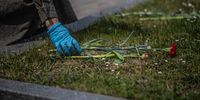 A woman wearing protective gloves attends a ceremony to honor the 75th anniversary of VE Day at the Olsany cemetery in Prague, Czech Republic. (Photo: EPA-EFE / Martin Divisek)