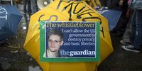 A poster showing a photograph of US whistleblower Edward Snowden is fixed to an umbrella during a pro-Snowden march in Hong Kong, China, 15 June 2013.  EPA/JEROME FAVRE