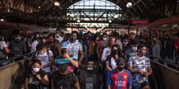 Commuters wearing protective masks walk onto excalators inside the Luz train station in Sao Paulo, Brazil, on Monday, June 22, 2020. Latin America's most populous country is only the second nation to reach the grim milestone of 1 million cases and, like in the U.S., the surge can be traced to reopenings and social distancing measures being lifted. Photographer: Jonne Roriz/Bloomberg via Getty Images