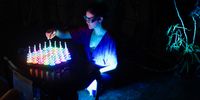A festival goer plays a game in the “Digital Garden” installation at Playtopia. The installation combined the work of game developers and a botanical artist. Photo: Christi Nortier