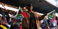 An audience member at the presidential inaugeration at Loftus Stadium in Pretoria salutes.