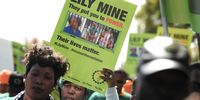 Association of Mineworkers and Construction Union (AMCU) members gather outside the Department of Mineral Resources offices during a protest for the three miners still trapped at the Lily mine on August 18, 2016 in Pretoria, South Africa. Pretty Nkambule, Solomon Nyarenda and Yvonne Mnisi were trapped underground when a mine collapsed on February 05, 2016. (Photo: Gallo Images / Thapelo Maphakela)