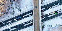 STAFFORD COUNTY, VIRGINIA - JANUARY 04: In an aerial view, traffic creeps along Virginia Highway 1 after being diverted away from I-95 after it was closed due to a winter storm on January 04, 2022 near Fredericksburg in Stafford County, Virginia. A winter storm with record snowfall slammed into the Mid-Atlantic states, stranding thousands of motorists overnight on 50 miles of I-95 in Virginia.  (Photo by Chip Somodevilla/Getty Images)