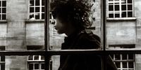 3 May 1966: Bob Dylan is seen walking past a shop window in London, England. (Photograph by Unknown/ Mirrorpix/ Mirrorpix via Getty Images)