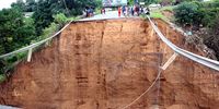 This bridge at Nhlungwane extension was washed away, leaving a crater. It was on the main road connecting Ntuzuma and areas such as Inanda and KwaMashu. (Photo: Mandla Langa)