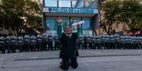 A member of the Malon de la Paz kneels between protesters and police to try and stop clashes between them, during a protest to demand justice for the death in a police operation of Facundo Molares Schoenfeld, at the Obelisco in Buenos Aires, Argentina, 11 August 2023. (Photo: EPA-EFE/Luciano Gonzalez)