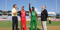 Kenyan captain Steve Tikolo tosses the coin watched by commentator Mike Atherton (L), Canadian captain John Davison and match referee Mike Procter during the ICC Cricket World Cup Group C match between Canada and Kenya at the Beausejour Cricket Ground on March 14, 2007 in Gros Islet, Saint Lucia.  (Photo by Clive Mason/Getty Images)